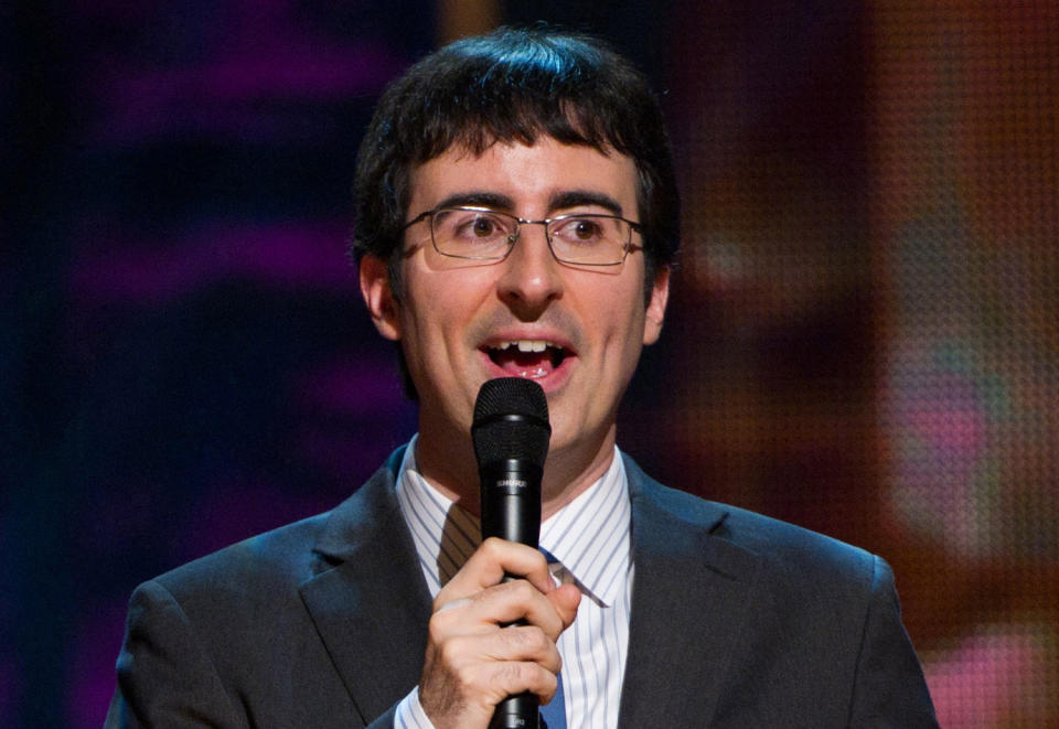 FILE - In this Oct. 2, 2010 file photo, John Oliver appears on stage at Comedy Central's 'Night Of Too Many Stars: An Overbooked Concert For Autism Education' at the Beacon Theatre in New York. Starting Monday, June 10, 2013, Oliver will preside on "The Daily Show" on Comedy Central. He will substitute-anchor for eight weeks of new shows before Jon Stewart's return on Sept. 3. (AP Photo/Charles Sykes)