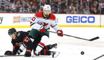 New Jersey Devils left wing Tomas Tatar (90) plays the puck against Ottawa Senators center Shane Pinto (57) during the first period of an NHL hockey game, Saturday, March 25, 2023, in Newark, N.J. (AP Photo/Noah K. Murray)