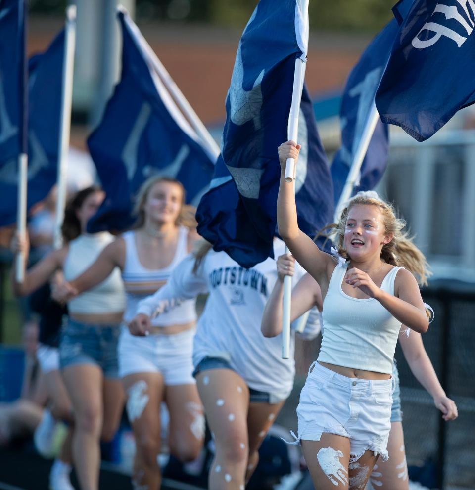 Rootstown students run the flags after a Rover touchdown during Friday night's home victory over Crestwood.
