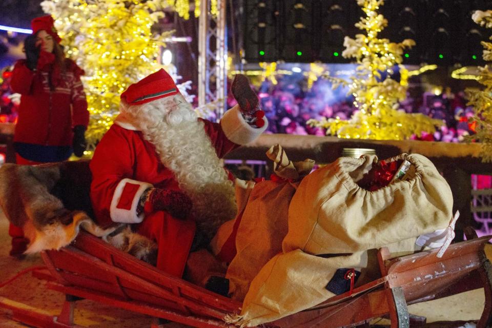 Santa Claus waves from his sleigh before leaving on his long Christmas journey from Santa's Village at the Arctic Circle in Finnish Lapland (AFP/Getty Images)