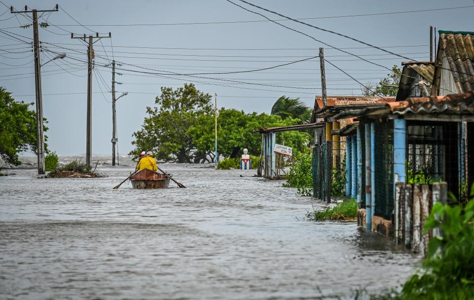 Man sails on a boat to safe zones in a flooded street after the passage of Hurricane Helene in Guanimar, Cuba (AFP via Getty Images)