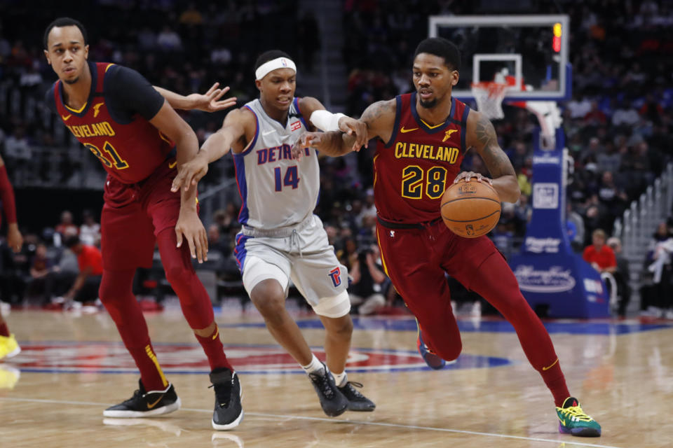 Cleveland Cavaliers forward Alfonzo McKinnie (28) drives as Detroit Pistons forward Louis King (14) defends during the first half of an NBA basketball game, Monday, Jan. 27, 2020, in Detroit. (AP Photo/Carlos Osorio)