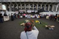 Women identified as victims of human rights violations during Guatemala's civil war, and their supporters, pray outside the Supreme Court in Guatemala City, Monday, Jan. 24, 2022. A decision at another court nearby is expected on Monday in the trial of five former civil defense patrolmen who fought alongside soldiers as civilians who are accused of sexual assault and human rights violations against dozens of Indigenous women from the Mayan Achi ethnic group. (AP Photo/Moises Castillo)