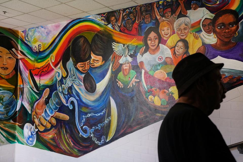 Artist Raul Valdez visits the mural he painted that is displayed in the School of Social Work at the University of Texas Thursday, May 11, 2023. 