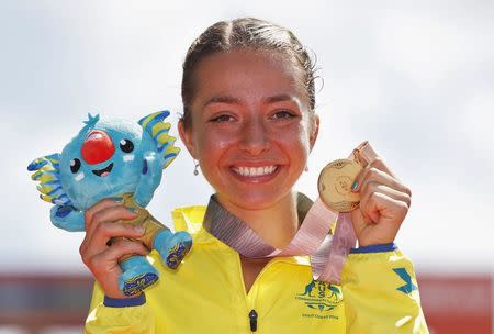 Athletics - Gold Coast 2018 Commonwealth Games - Women's 20km Race Walk Final - Currumbin Beachfront - Gold Coast, Australia - April 8, 2018. Gold medallist Jemima Montag of Australia poses with her medal and Borobi plush doll. REUTERS/Paul Childs