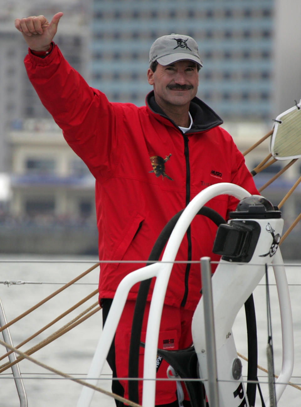 FILE - In this Nov. 12, 2005 file photo Pirates of the Caribbean skipper American Paul Cayard waves as he sails out of the Vigo Harbour, northern Spain prior to the start of the Volvo Ocean Race 2005. Cayard has raced in the America's Cup, the Olympics and was the first American skipper to win one of sailing's toughest challenges, the Whitbread Round the World Race. Now he faces another arduous task, guiding the underperforming U.S. Olympic sailing team as its new executive director. (AP Photo/Lalo R. Villar, File)