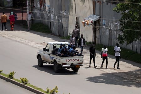 Armed security officers patrol the street during a clash between a Sidama youth and a securities after they declared their own region in Hawassa