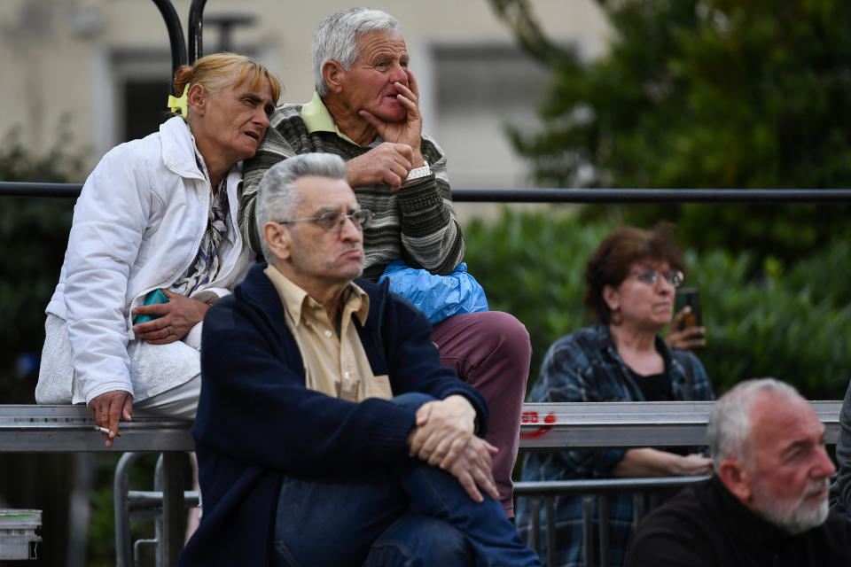 Supporters of Syriza watch the exit polls at the main polling kiosk of their party at Klafthmonos square, in central Athens, Greece, Sunday, May 21, 2023. Exit polls in Greece's parliamentary elections show Prime Minister Kyriakos Mitsotakis' conservative party is in the lead but is unlikely to win enough seats in parliament to form a government outright. (AP Photo/Michael Varaklas)