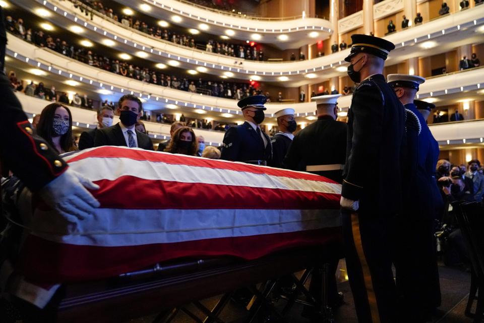 People watch as the flag-draped casket of former Senate Majority Leader Harry Reid arrives a memorial service at the Smith Center in Las Vegas, Saturday, Jan. 8, 2022.