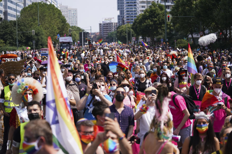 People take part in the Christopher Street Day (CSD) parade, in Berlin, Saturday, July 24, 2021. The official motto of the CSD is "Save our Community - save our Pride". (J'rg Carstensen/dpa via AP)