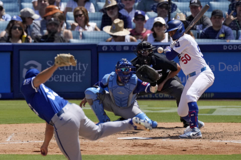 Los Angeles Dodgers' Mookie Betts, right, is hit by a pitch as Kansas City Royals relief pitcher Dan Altavilla, left, watches along with catcher Freddy Fermin, second from left, and home plate umpire Ryan Additon during the seventh inning of a baseball game Sunday, June 16, 2024, in Los Angeles. (AP Photo/Mark J. Terrill)