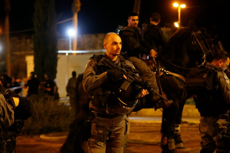 Israeli police stand guard where a Palestinian man was shot dead by security forces after he opened fire near the Damascus Gate, a main entrance to Jerusalem's Old City on February 14, 2016