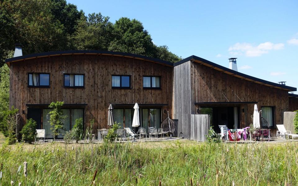 Wood-clad cottages at Villages Nature Paris nestle into the surroundings