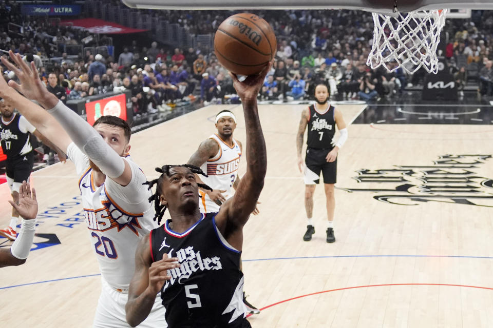 Los Angeles Clippers guard Bones Hyland, right, shoots as Phoenix Suns center Jusuf Nurkic defends during the first half of an NBA basketball game Wednesday, April 10, 2024, in Los Angeles. (AP Photo/Mark J. Terrill)