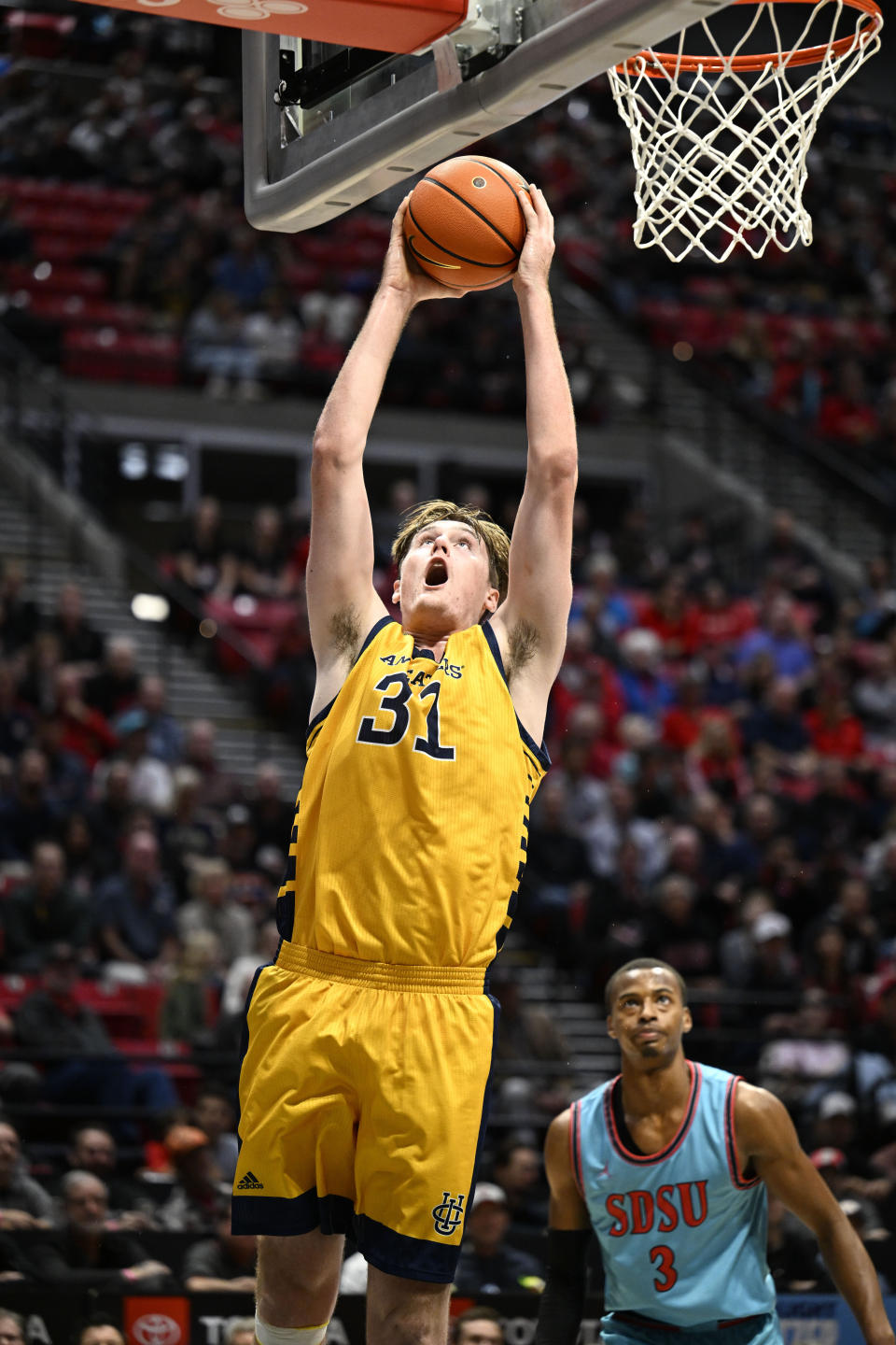 UC Irvine forward Dean Keeler (31) shoots as San Diego State guard Micah Parrish (3) watches during the first half of an NCAA college basketball game Tuesday, Nov. 29, 2022, in San Diego. (AP Photo/Denis Poroy)