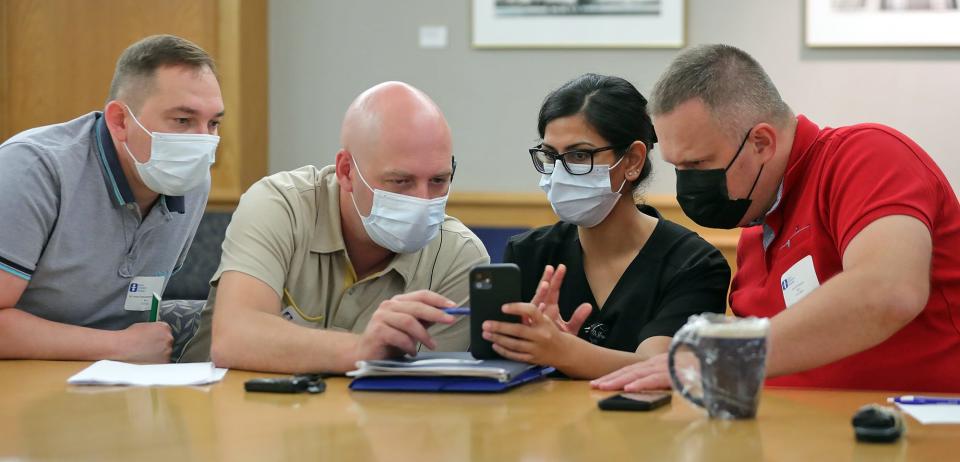 Dr. Steffi Sharma, center, discusses a recent patient's burns with Ukrainian doctors Anton Oleksandrovych Kovalenko, left, Anton Ihorovych Halata, left center, and Artem Ivanovych Posunko during a meeting at Akron Children's Hospital on Wednesday.