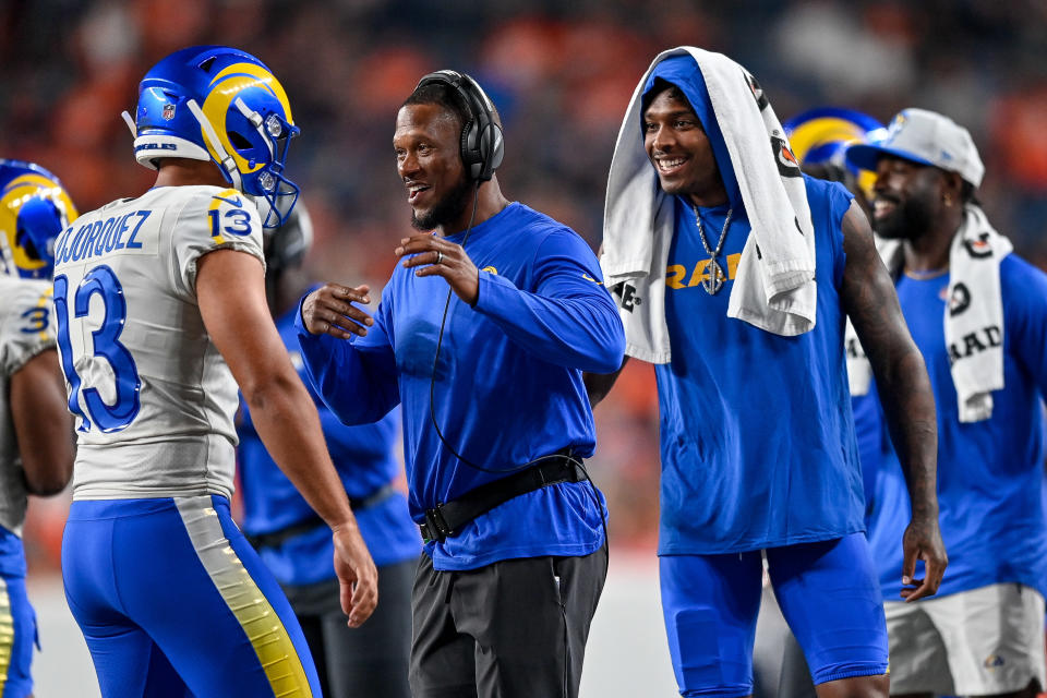 DENVER, COLORADO - AUGUST 28:  Running Backs Coach/Assistant Head Coach Thomas Brown and Jalen Ramsey #5 of the Los Angeles Rams celebrate with Corey Bojorquez #13 of the Los Angeles Rams after a punt during an NFL preseason game against the Denver Broncos at Empower Field at Mile High on August 28, 2021 in Denver, Colorado. (Photo by Dustin Bradford/Getty Images)