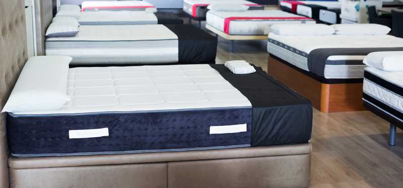 Mattresses on display inside a store.