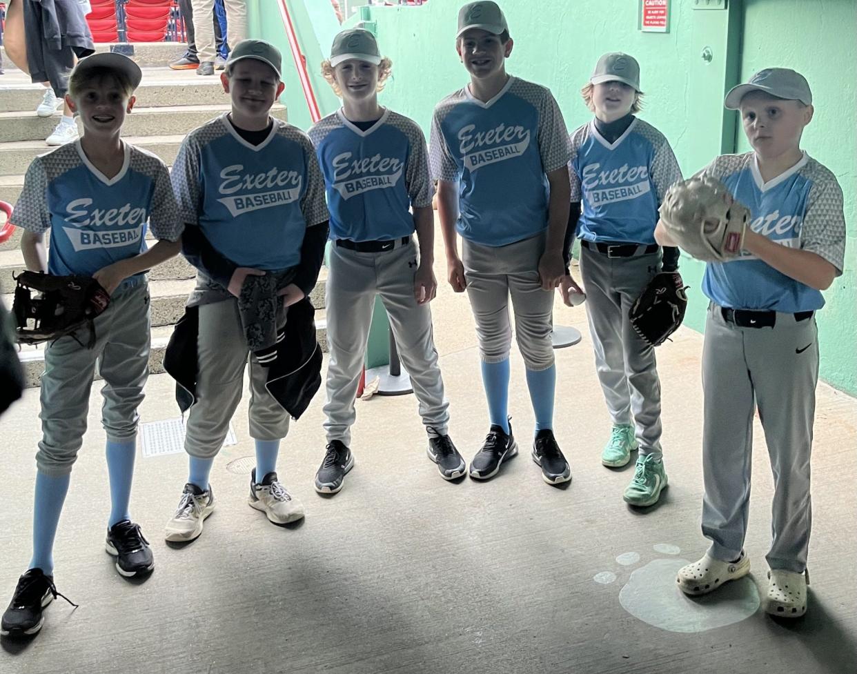 The Exeter Cal Ripken team of 12-and-under baseball players made an appearance on the field at Fenway Park in Boston, shaking hands with Red Sox players, Wednesday, April 17, 2024.