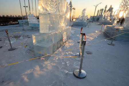 Security lines are seen set up for protecting visitors from falling ice from melting ice sculptures at the venue of the Harbin International Ice and Snow Sculpture Festival on its closing day, in Heilongjiang province, China February 17, 2019. REUTERS/Stringer