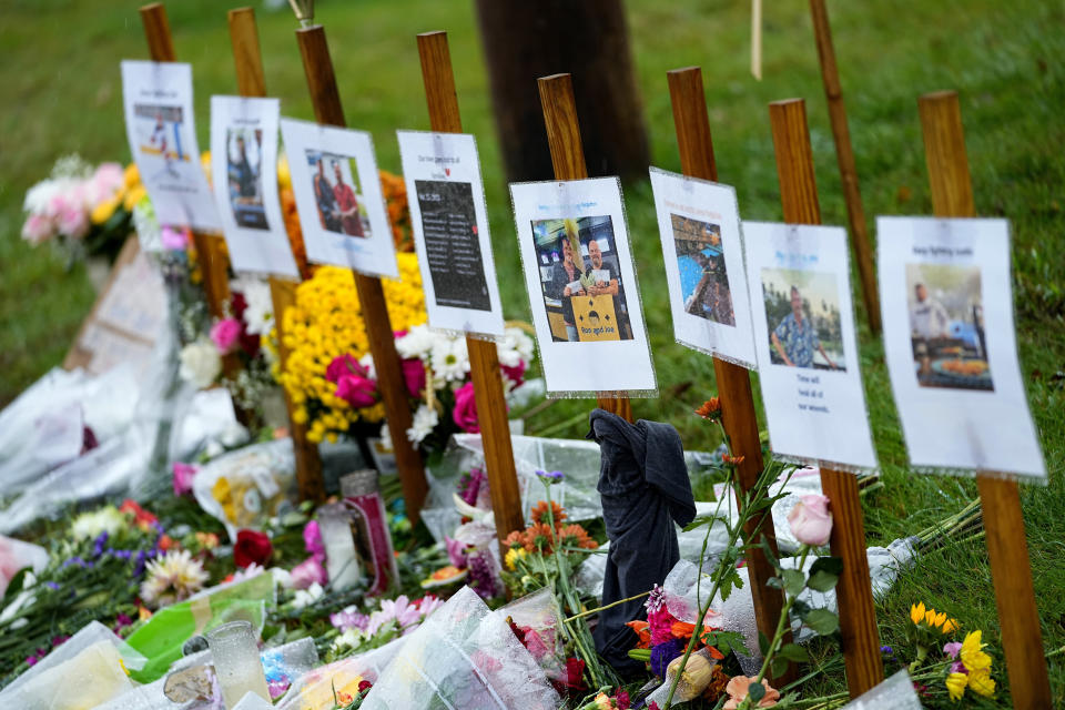 FILE - Rain soaked memorials for those who died in a mass shooting sit along the roadside by Schemengees Bar & Grille, Monday, Oct. 30, 2023, in Lewiston, Maine. An independent commission investigating this deadliest shooting in Maine history is going to hear from state police Thursday, Feb. 15, 2024, the lead law enforcement agency. (AP Photo/Matt York, File)