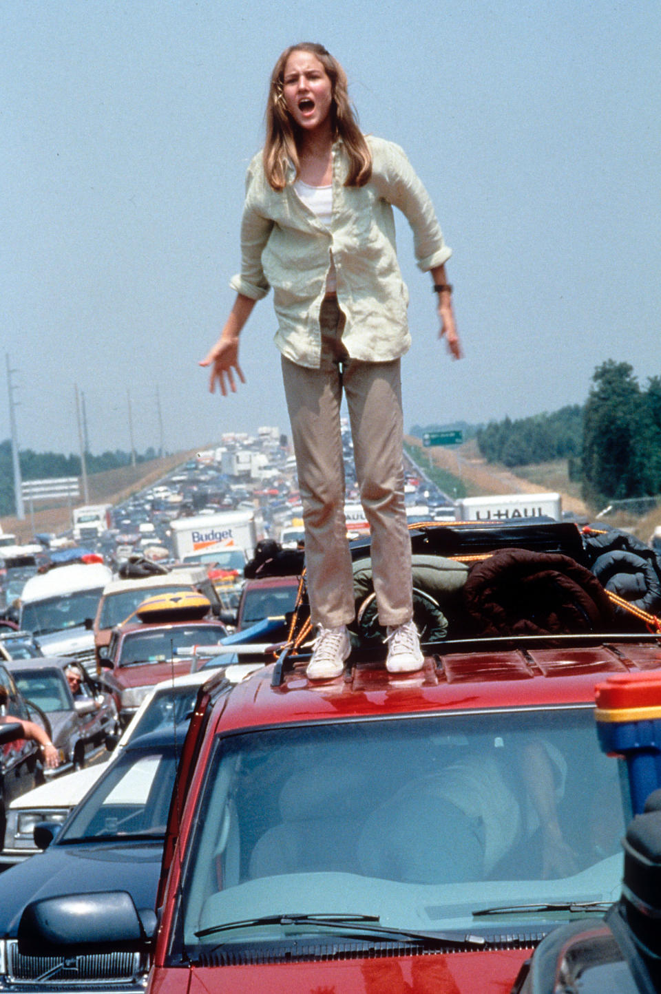 Leelee Sobieski standing on a roof of a car in a scene from the film &#39;Deep Impact&#39;, 1998. (Photo by Paramount Pictures/Getty Images)