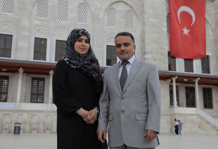 Mustafa El Sagezli, General Manager of Libyan Programme for Reintegration and Development (LPRD), and his wife Badia pose in front of the Fatih Mosque in Istanbul, Turkey May 11, 2018. Picture taken May 11, 2018. REUTERS/Huseyin Aldemir
