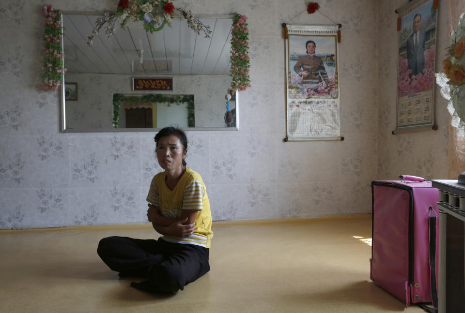 In this photo taken on Sunday, Sept. 23, 2012, North Korean farmer O Yong Ae sits at her home during an interview at the Migok Cooperative farm in Sariwon, North Hwanghae Province, North Korea. Farmers would be able to keep a bigger share of their crops under proposed changes aiming to boost production by North Korea's collective farms, which have chronically struggled to provide enough food for the country's 24 million people. Current rules require them to turn everything over to the state beyond what farmers can keep to feed their families. (AP Photo/Vincent Yu)