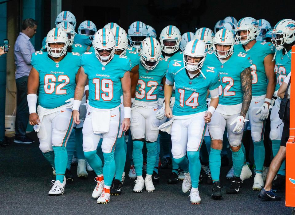 Quarterbacks Skylar Thompson (19) and Mike White (14) lead the Miami Dolphins on the field before an NFL preseason game at Hard Rock Stadium on Friday, August 11, 2023, in Miami Gardens, FL.