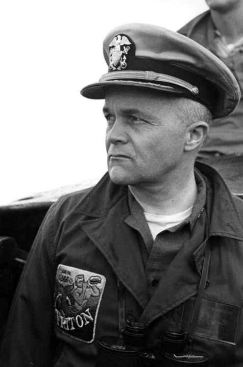 Captain Edward L. Beach, USN, Commanding Officer of the USS Triton (SSBN-586) on the bridge of the submarine immediately after the conning tower breached for the first time after the world’s largest-nuclear submarine completed its historic submerged circumnavigation of the world.”