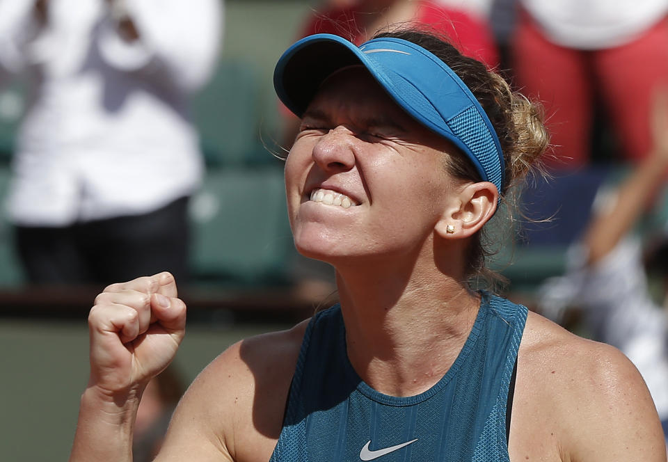 Romania's Simona Halep clenches her fist after defeating Spain's Garbine Muguruza during their semifinal match at the French Open tennis tournament in Paris on June 7, 2018. Halep won 6-1, 6-4. (AP Photo/Michel Euler)