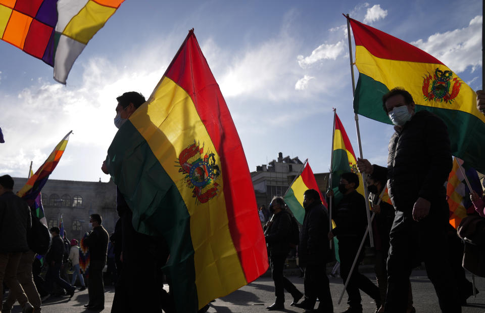 Demonstrators hold Bolivian flags as they march demanding jail time for opposition leader and governor of Santa Cruz region Luis Fernando Camacho in La Paz, Bolivia, Thursday, Jan. 12, 2023. Prosecutors on Dec. 29 remanded Camacho into custody for four months while he faces terrorism charges. (AP Photo/Juan Karita)
