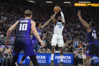 Dallas Mavericks forward Tim Hardaway Jr. (10) shoots between Sacramento Kings guard Malik Monk (0), forward Domantas Sabonis (10) and forward Harrison Barnes (40) in the first half of an NBA basketball game in Sacramento, Calif., Tuesday, March 26, 2024. (AP Photo/José Luis Villegas)