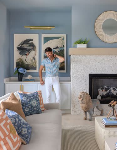 <p>Jessie Preza </p> Brian Patrick Flynn poses next to the fireplace made out of coquina.