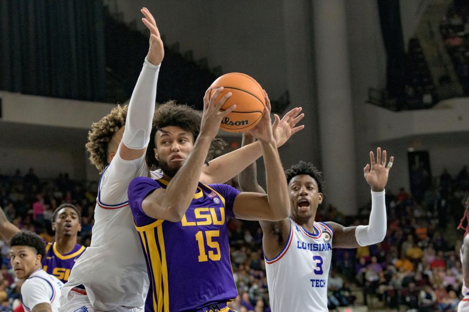 LSU center Efton Reid (15) shoots against Louisiana Tech forward Kenny Hunter, front left, during the second half of an NCAA college basketball game in Bossier City, La., Saturday, Dec. 18, 2021. (AP Photo/Matthew Hinton)