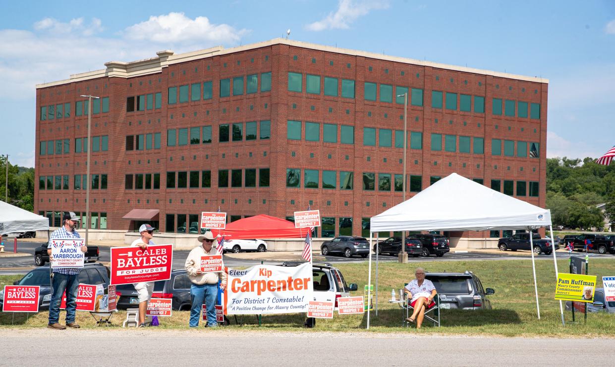 Candidates campaign outside of a polling station during early voting in Columbia, TN. 