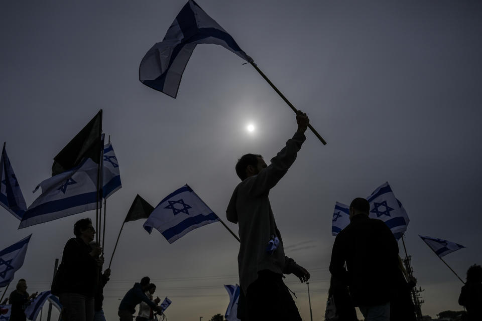 Israelis protest against plans by Prime Minister Benjamin Netanyahu's government to overhaul the judicial system in Beit Beit Yanai interchange as they block the free way, Israel, Thursday, March 23, 2023. (AP Photo/Ariel Schalit)