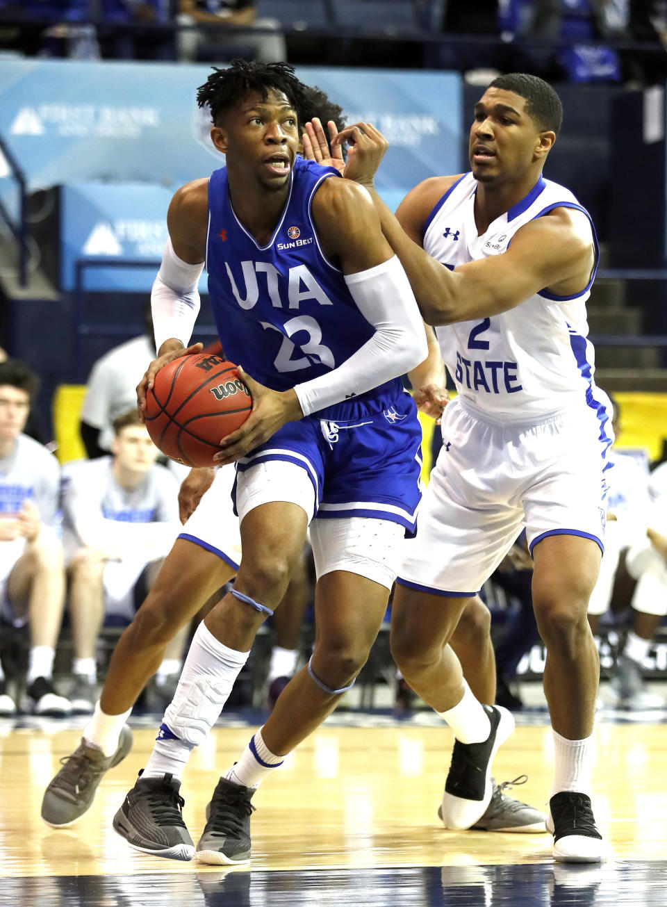 Texas-Arlington forward Patrick Mwamba (23) drives past Georgia State forward Malik Benlevi (2) during the first half of the NCAA college basketball championship game of the Sun Belt Conference men's tournament in in New Orleans, Sunday, March 17, 2019. (AP Photo/Tyler Kaufman)