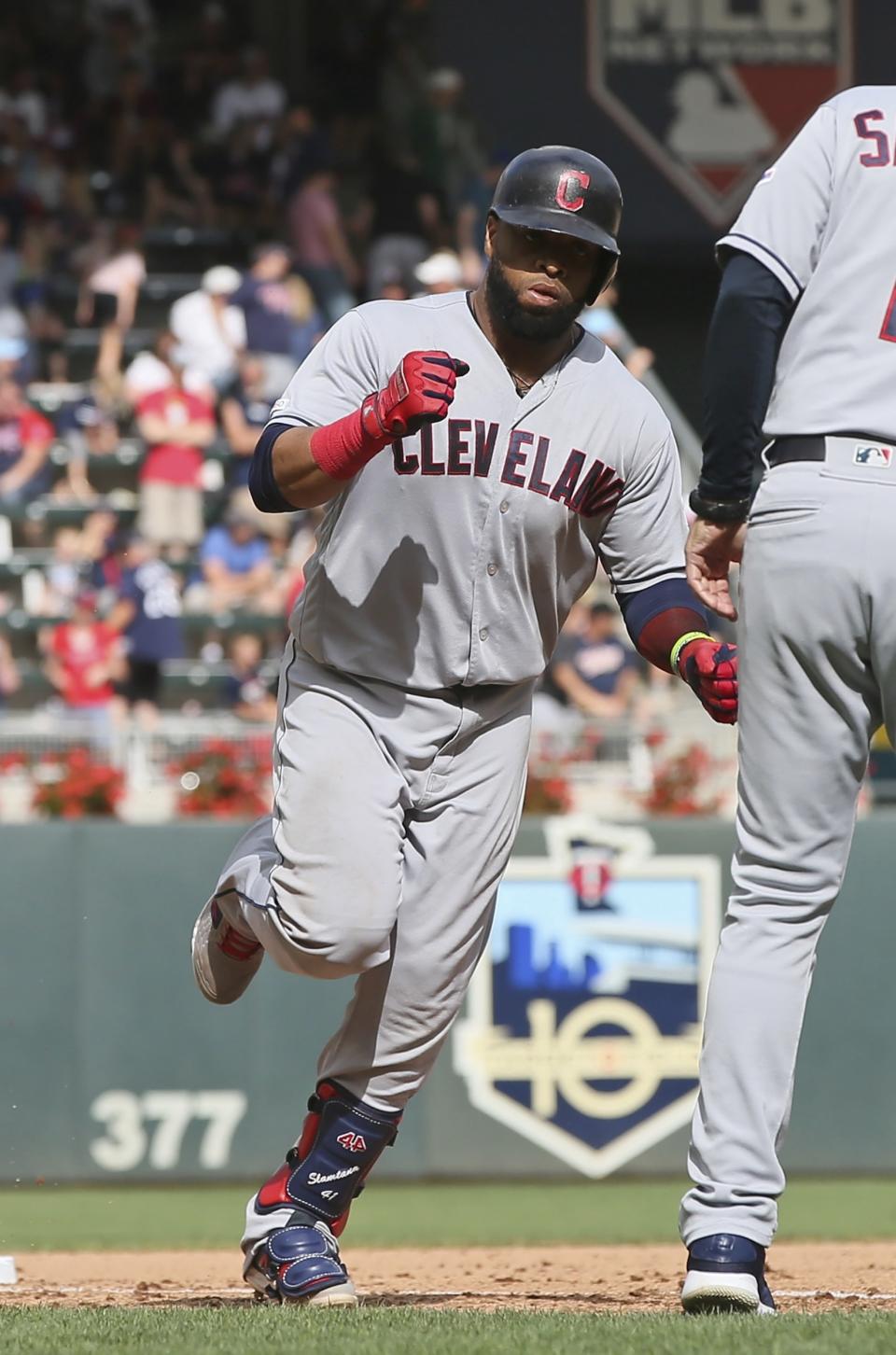 Cleveland Indians' Carlos Santana rounds third base on a grand slam off Minnesota Twins pitcher Taylor Rogers in the 10th inning of a baseball game Sunday, Aug. 11, 2019, in Minneapolis. The Indians won 7-3. (AP Photo/Jim Mone)