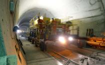 Workers drive on a special vehicle during the installation of the railway tracks in the NEAT Gotthard Base tunnel near Erstfeld May 7, 2012. Crossing the Alps, the world's longest train tunnel should become operational at the end of 2016. The project consists of two parallel single track tunnels, each of a length of 57 km (35 miles)