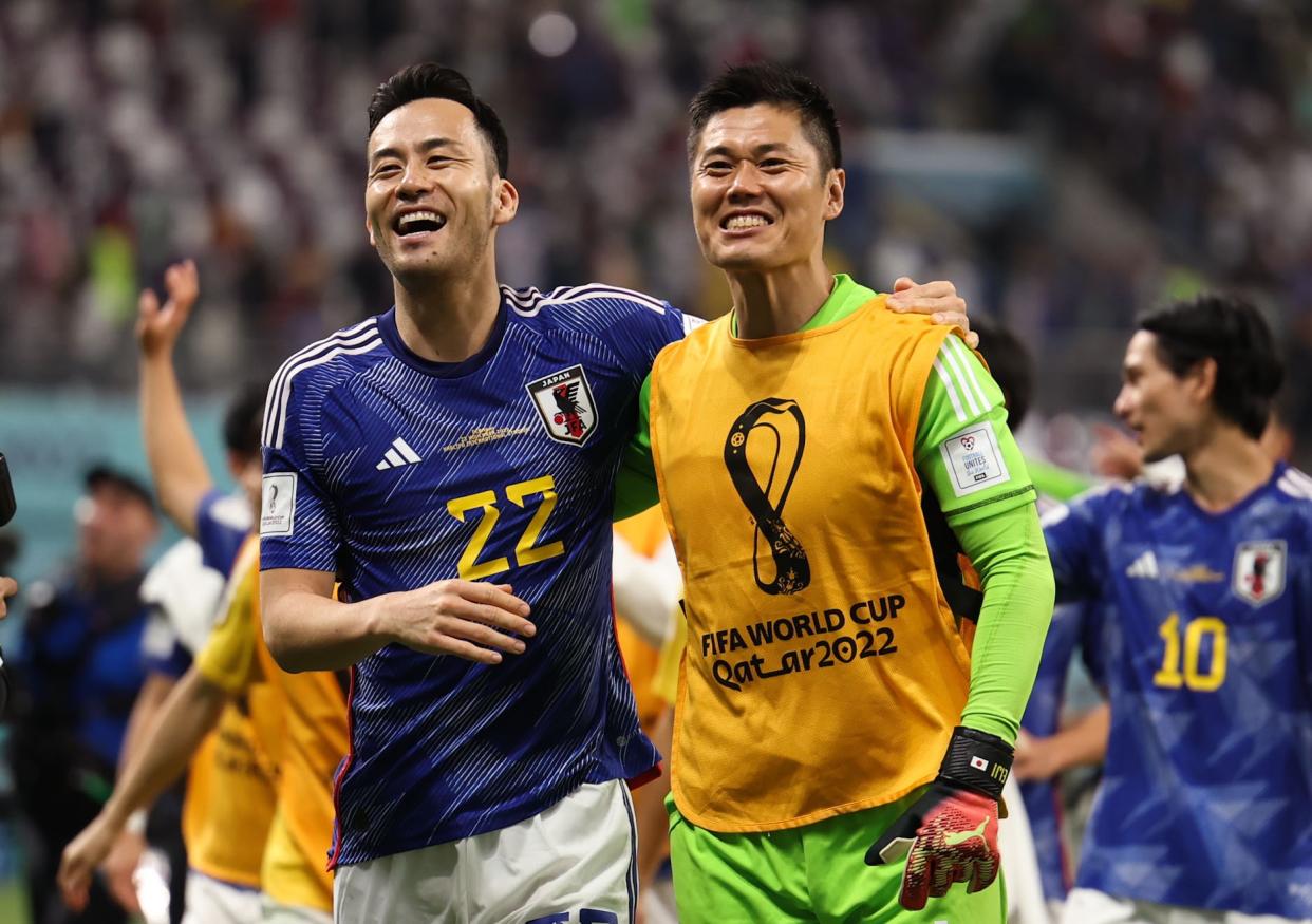 Yoshida Maya L and Kawashima Eiji of Japan celebrate after the Group E match between Germany and Japan at the 2022 FIFA World Cup at Khalifa International Stadium in Doha, Qatar, Nov. 23, 2022. (Photo by Pan Yulong/Xinhua via Getty Images)