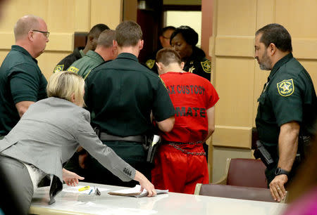 Nikolas Cruz, facing 17 charges of premeditated murder in the mass shooting at Marjory Stoneman Douglas High School in Parkland, walks out of his status hearing before Broward Circuit Judge Elizabeth Scherer in Fort Lauderdale, Florida, U.S. February 19, 2018. REUTERS/Mike Stocker/Pool