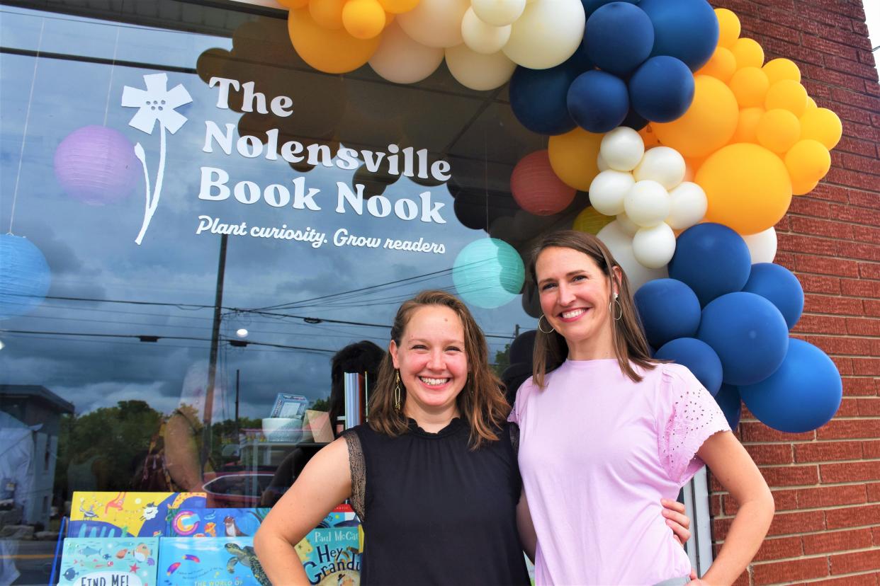 Jessica Bates (left), a writer, and Dr. Liz Kiilerich-Bowles, a teacher, have been close friends since middle school.  The mothers and business partners share a moment outside the grand opening of their kid's bookstore on Sunday, July 31, 2022, in historic downtown Nolensville, Tenn.