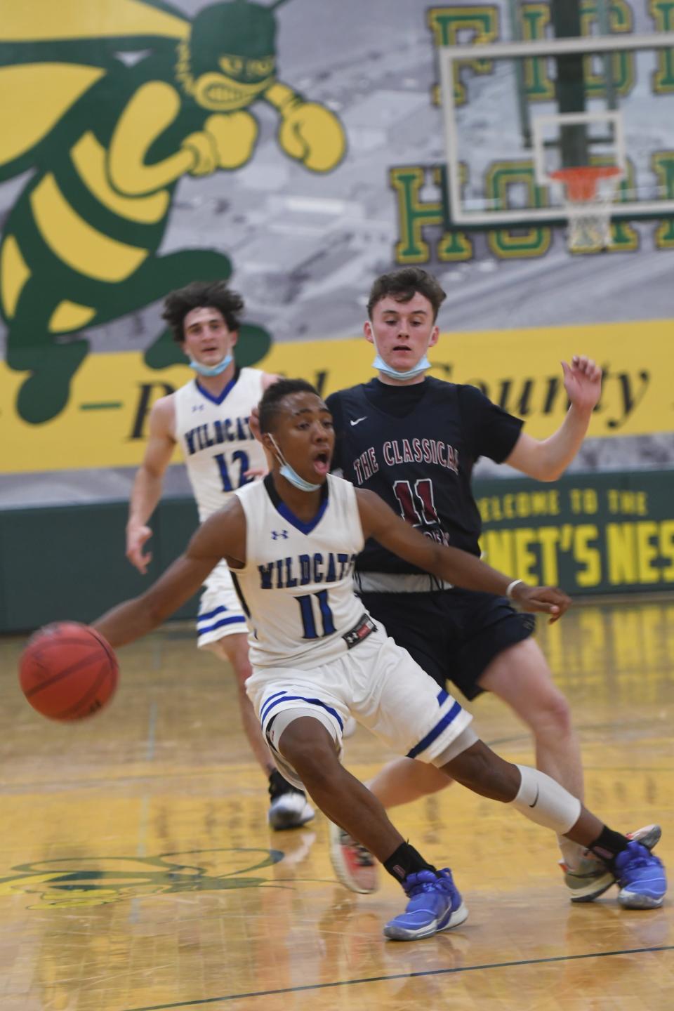 Syris Williams crosses over during a tournament game at Pueblo County High School in December 2021.