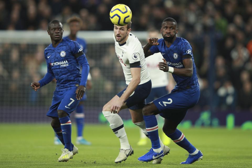 Tottenham's Harry Kane and Chelsea's Antonio Rudiger, right, eye the ball during the English Premier League soccer match between Tottenham Hotspur and Chelsea, at the Tottenham Hotspur Stadium in London, Sunday, Dec. 22, 2019. (AP Photo/Ian Walton)