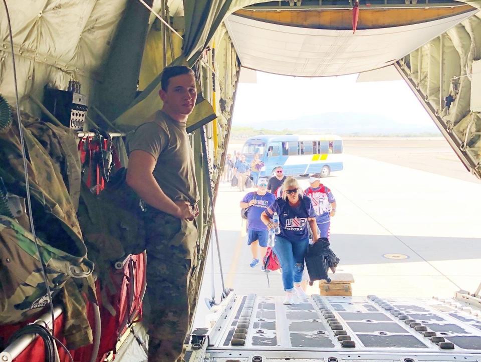 Team USA members of the Americas Women's Bowl board a C-130 sent by President Trump to bring them home from Honduras as the coronavirus pandemic broke out across the world. (Courtesy of AFE)  