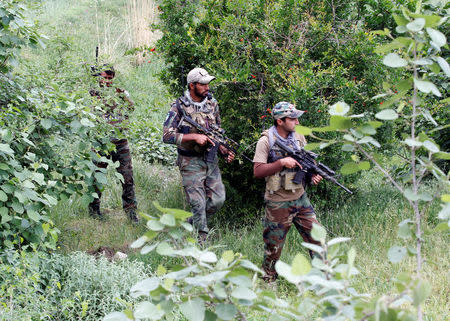 Afghan Special Forces patrol at the site of a MOAB, or ''mother of all bombs'', which struck the Achin district of the eastern province of Nangarhar, Afghanistan April 23, 2017. REUTERS/Parwiz