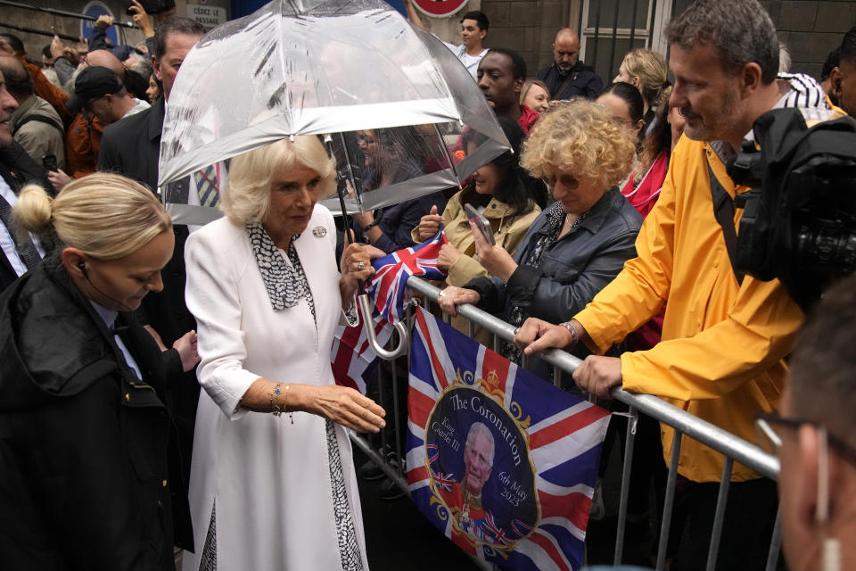 Britain's Queen Camilla meets residents after visiting the Flower Market Thursday, Sept. 21, 2023 in Paris. The royal couple's trip started Wednesday with a ceremony at Arc de Triomphe in Paris and a state dinner at the Palace of Versailles. King Charles will rejoin French President Emmanuel Macron in front of Notre-Dame Cathedral to see the ongoing renovation work aimed at reopening the monument by the end of next year, after it was devastated by a fire in 2019.(AP Photo/Christophe Ena; Pool)