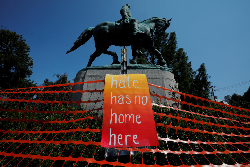 <p>A sign reading “Hate Has No Home Here” hangs by the statue of Civil War Confederate General Robert E. Lee, ahead of the one year anniversary of 2017 Charlottesville “Unite the Right” protests, in Charlottesville, Va., Aug. 10, 2018. (Photo: Brian Snyder/Reuters) </p>