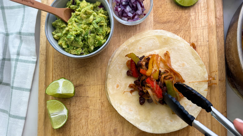 adding fajitas to tortilla